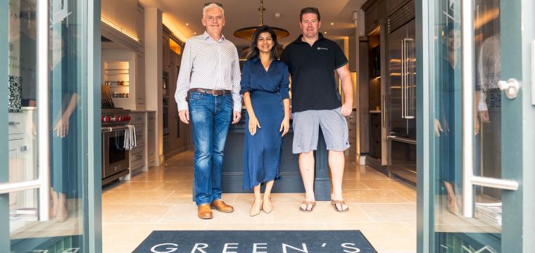 Three people stood inside Green's luxury kitchen