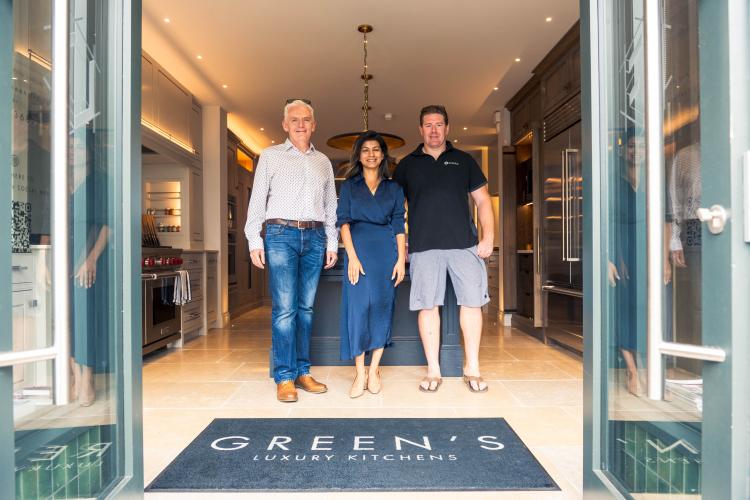 Three people stood inside Green's luxury kitchen